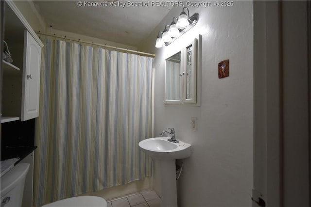 bathroom featuring tile patterned floors and toilet