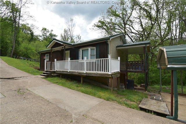 view of front of home with covered porch and central AC