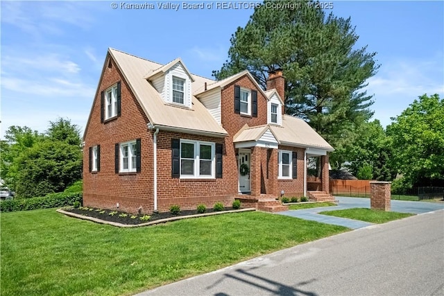 315 27th St SE, Charleston, WV 25304 - cape cod-style house featuring a chimney, brick siding, and a front yard