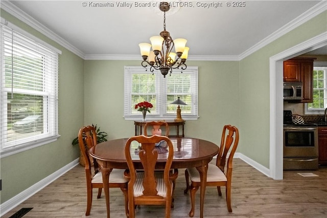 315 27th St SE, Charleston, WV 25304 - dining room with light wood finished floors, a notable chandelier, and baseboards
