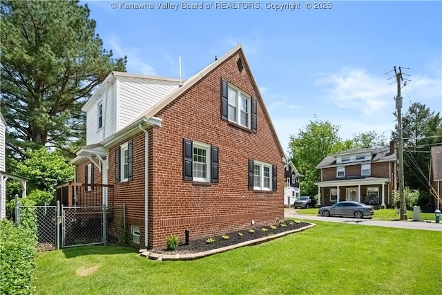 315 27th St SE, Charleston, WV 25304 - view of side of property with a yard, fence, and brick siding