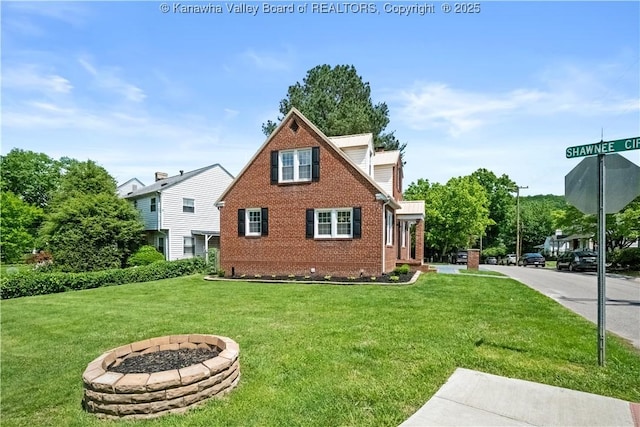 315 27th St SE, Charleston, WV 25304 - exterior space with a fire pit, brick siding, and a lawn