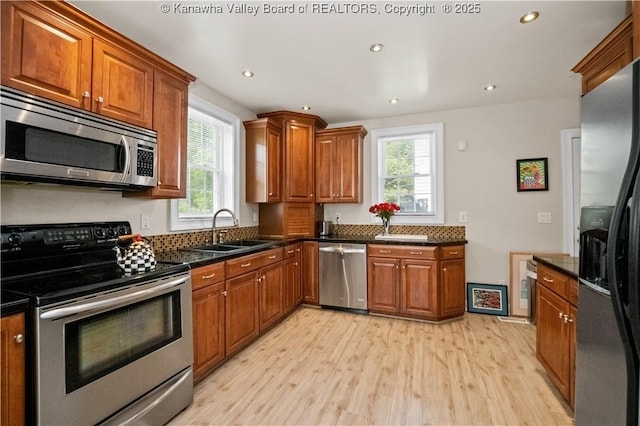 315 27th St SE, Charleston, WV 25304 - kitchen featuring a sink, brown cabinetry, light wood-style floors, and appliances with stainless steel finishes