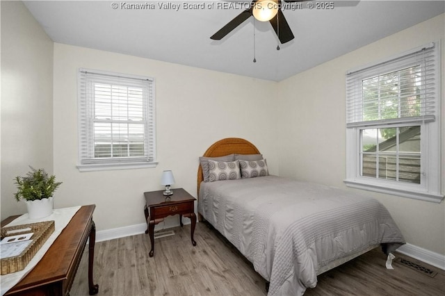 315 27th St SE, Charleston, WV 25304 - bedroom with baseboards, multiple windows, and wood finished floors