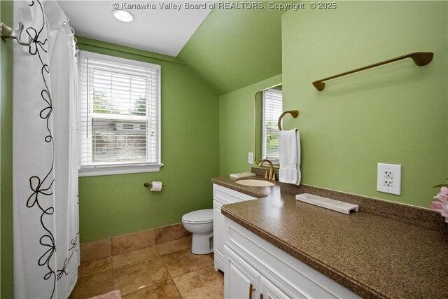 315 27th St SE, Charleston, WV 25304 - bathroom featuring vaulted ceiling, vanity, toilet, and tile patterned flooring