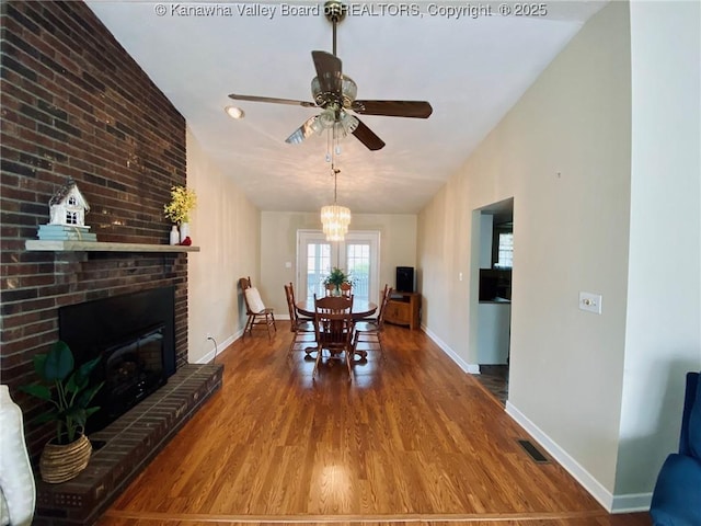 dining room with baseboards, visible vents, and wood finished floors
