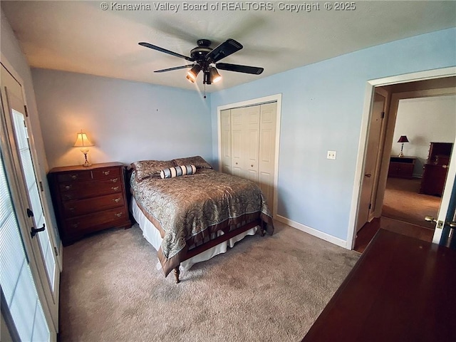 carpeted bedroom featuring ceiling fan, a closet, baseboards, and multiple windows