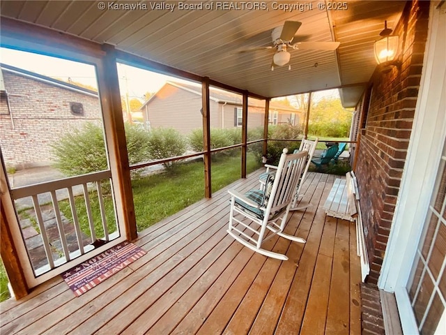 sunroom featuring ceiling fan