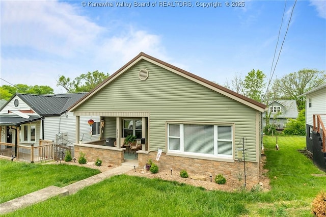 2258 Curtis Ave, Saint Albans, WV 25177 - bungalow-style house featuring stone siding, a patio area, and a front yard