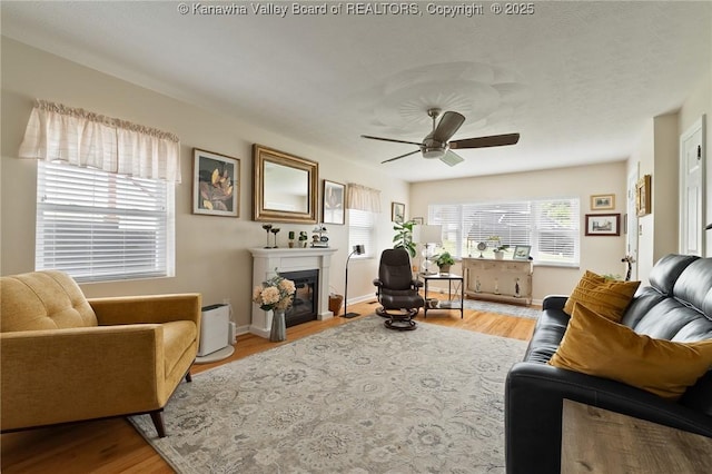 2258 Curtis Ave, Saint Albans, WV 25177 - living room featuring ceiling fan, a fireplace with flush hearth, and wood finished floors