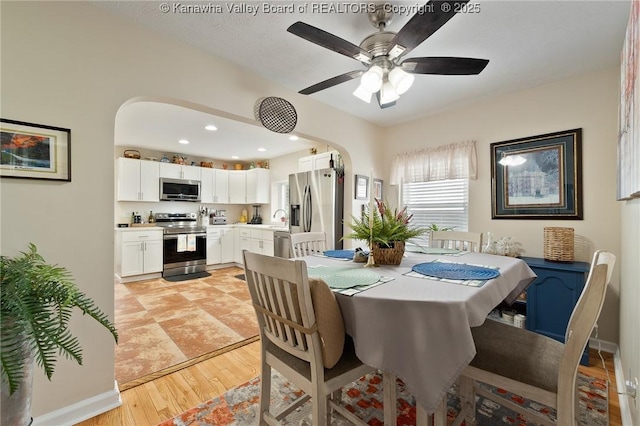 2258 Curtis Ave, Saint Albans, WV 25177 - dining area featuring arched walkways, light wood finished floors, and ceiling fan