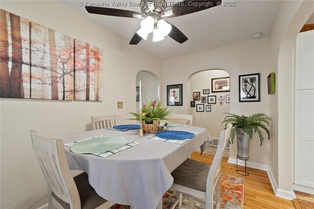 2258 Curtis Ave, Saint Albans, WV 25177 - dining area featuring light wood finished floors, arched walkways, a ceiling fan, and baseboards