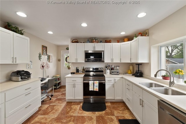 2258 Curtis Ave, Saint Albans, WV 25177 - kitchen with a sink, white cabinetry, light countertops, appliances with stainless steel finishes, and recessed lighting