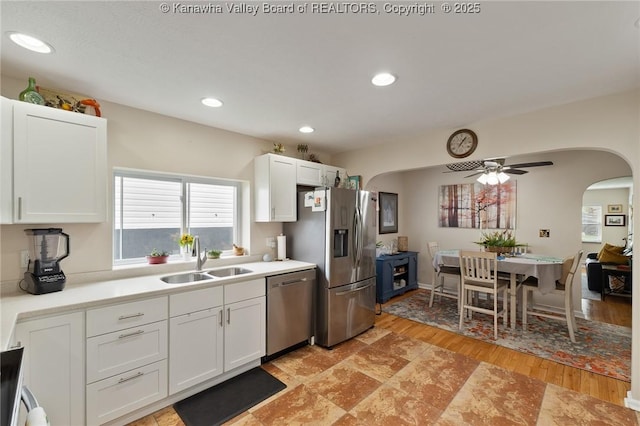 2258 Curtis Ave, Saint Albans, WV 25177 - kitchen featuring stainless steel appliances, a sink, arched walkways, light countertops, and white cabinets