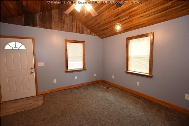 foyer entrance with baseboards, a wealth of natural light, wood ceiling, and vaulted ceiling