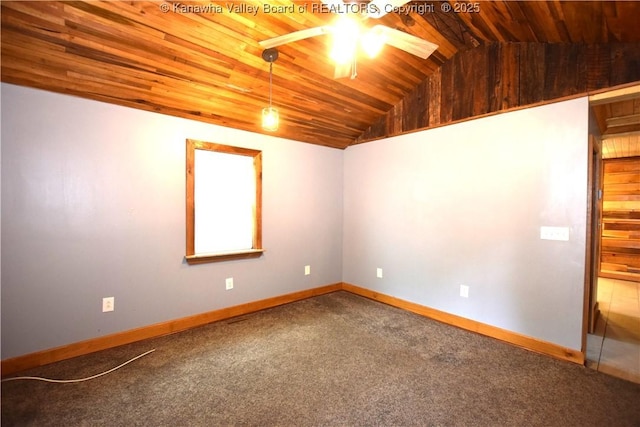 carpeted empty room with vaulted ceiling, wood ceiling, baseboards, and a ceiling fan