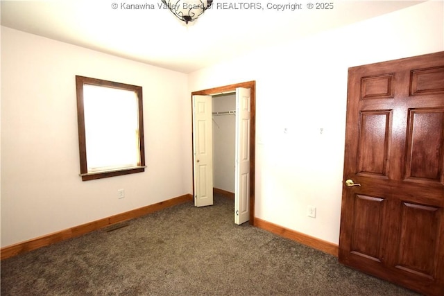 unfurnished bedroom with carpet, baseboards, and a closet