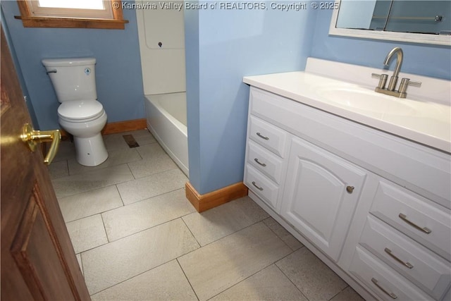 bathroom with a bathtub, toilet, baseboards, tile patterned floors, and vanity