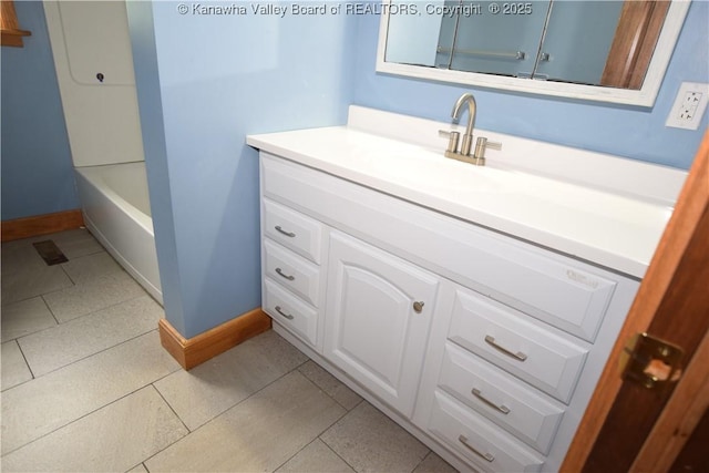 bathroom with tile patterned floors, baseboards, and vanity