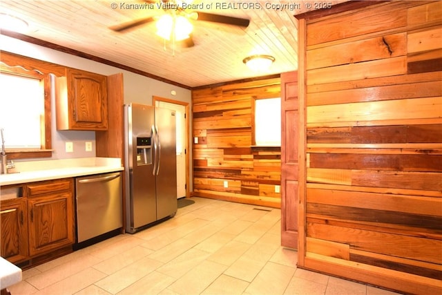 kitchen with wood walls, ceiling fan, light countertops, wood ceiling, and appliances with stainless steel finishes