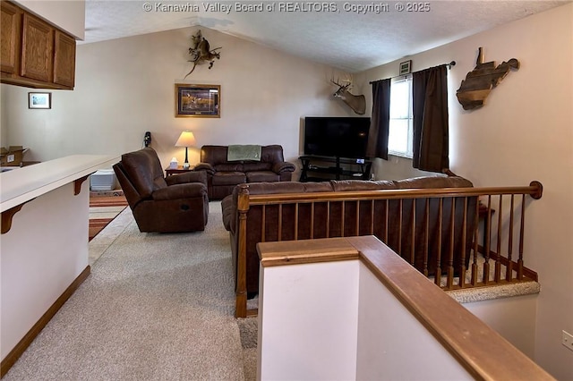 433 Kingswood Dr, Culloden, WV 25510 - carpeted living area featuring vaulted ceiling and baseboards