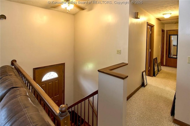 433 Kingswood Dr, Culloden, WV 25510 - foyer featuring a textured ceiling, baseboards, a ceiling fan, and carpet floors