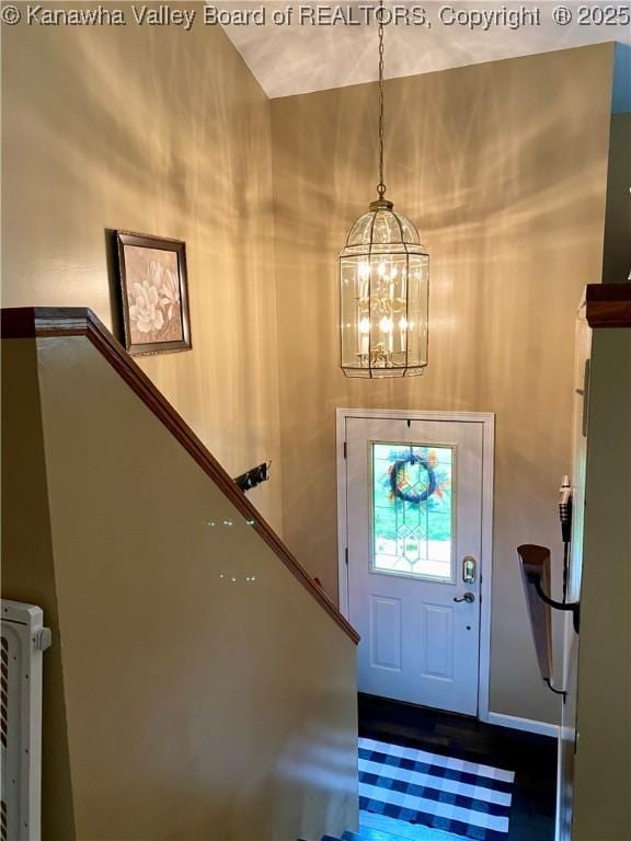 foyer featuring stairs and a notable chandelier