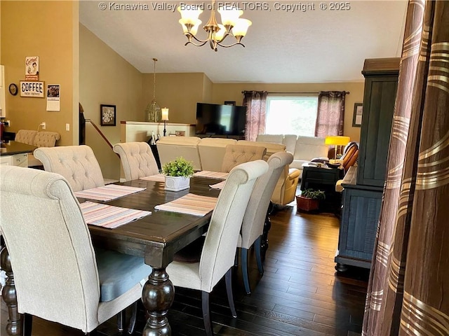 dining room featuring a chandelier, lofted ceiling, and dark wood-style floors