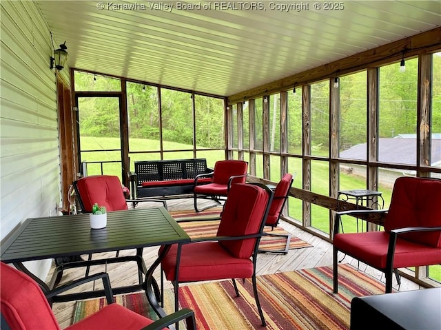 sunroom / solarium featuring a wealth of natural light and outdoor lounge area