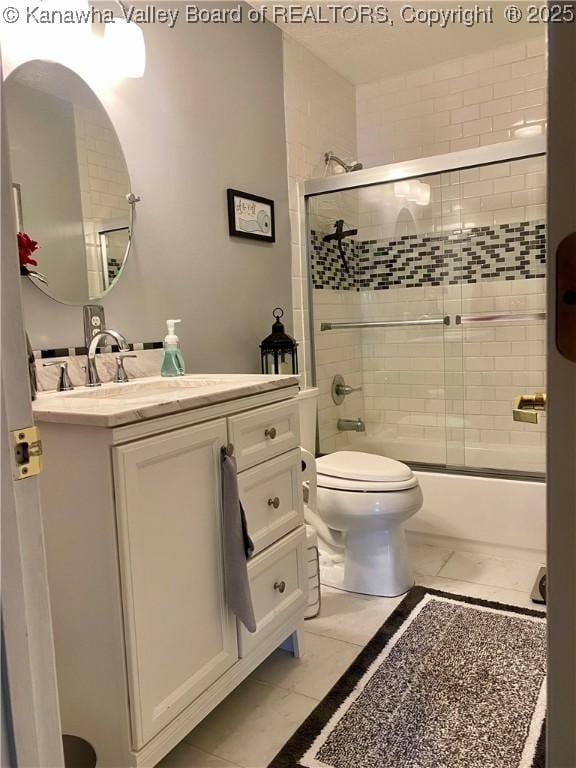 full bathroom featuring toilet, vanity, and shower / bath combination with glass door