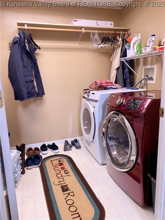 washroom featuring separate washer and dryer and laundry area