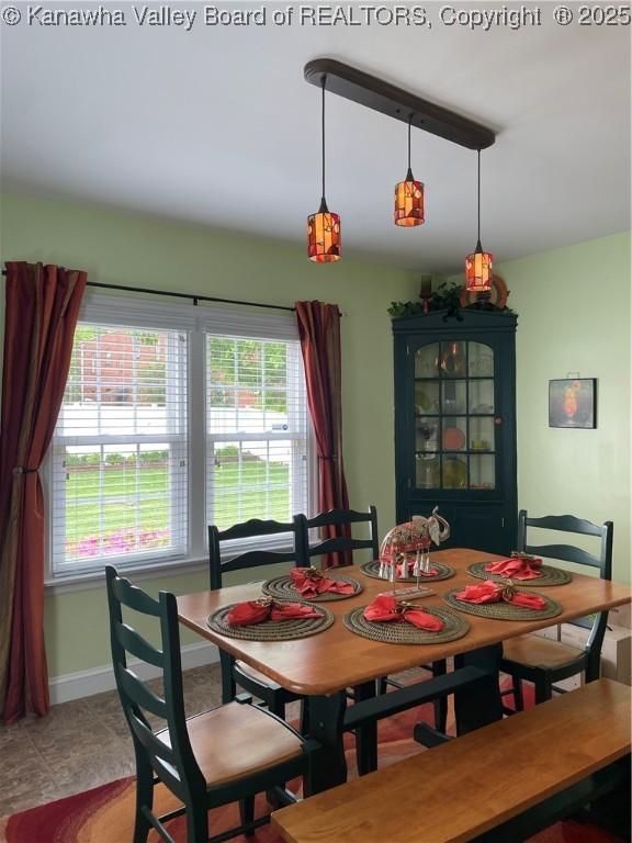 dining space with baseboards and plenty of natural light