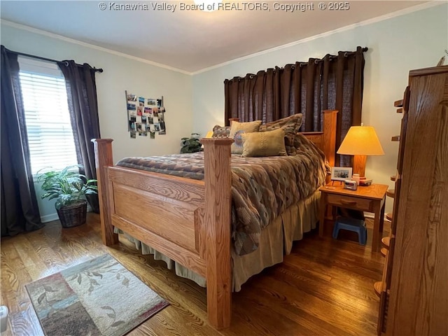 bedroom featuring crown molding and wood finished floors