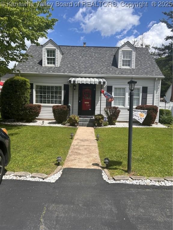 cape cod home featuring a front yard and roof with shingles