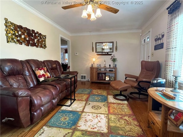 living area featuring ornamental molding, visible vents, ceiling fan, and wood finished floors
