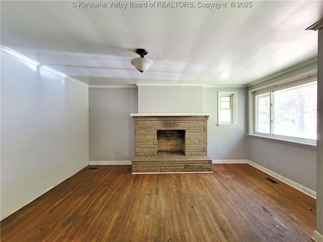 728 98th St, Charleston, WV 25315 - unfurnished living room featuring hardwood / wood-style flooring, baseboards, a stone fireplace, and visible vents