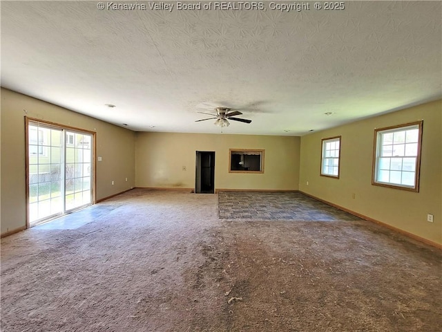 728 98th St, Charleston, WV 25315 - unfurnished living room with a ceiling fan, a textured ceiling, baseboards, and carpet