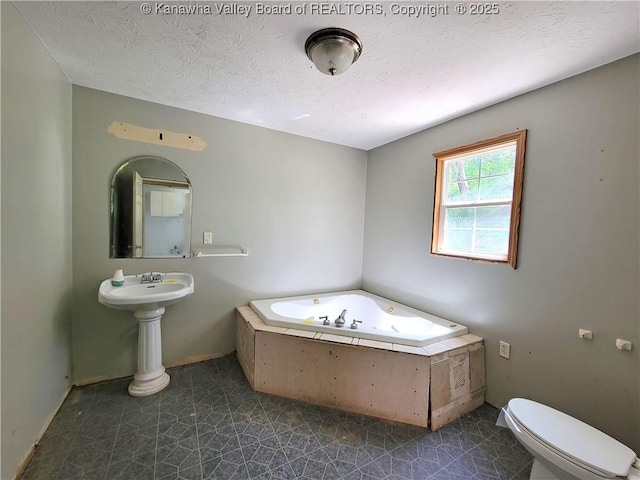 728 98th St, Charleston, WV 25315 - bathroom featuring toilet, a textured ceiling, tile patterned floors, and a bath