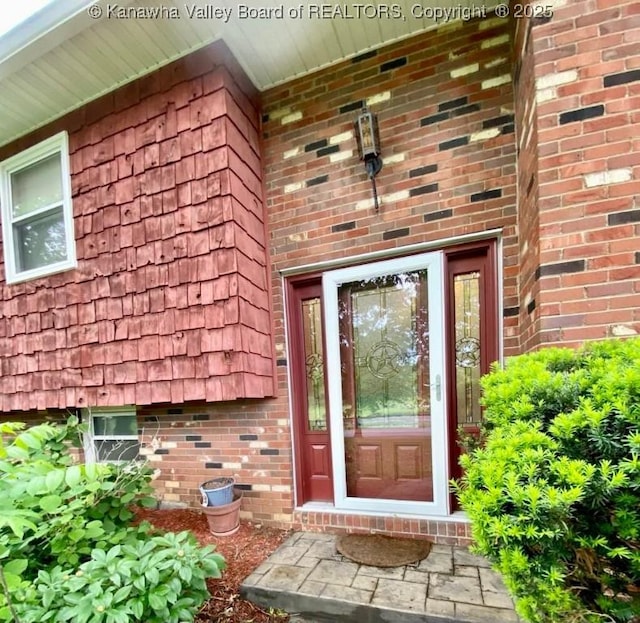 property entrance featuring brick siding