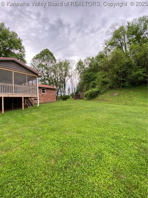 view of yard with a sunroom