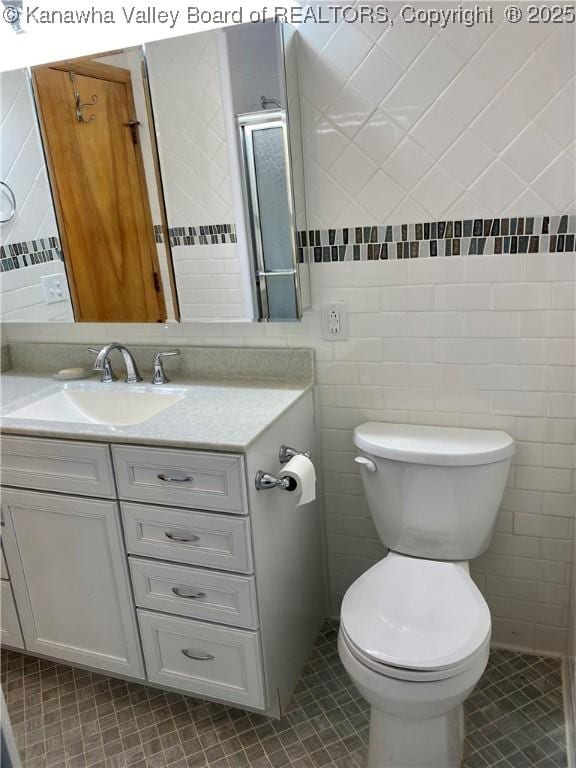 bathroom featuring tile walls, tile patterned floors, and vanity