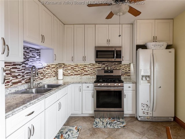 2648 Bedford Chapel, Milton, WV 25541 - kitchen featuring stainless steel appliances, a sink, ceiling fan, decorative backsplash, and white cabinets