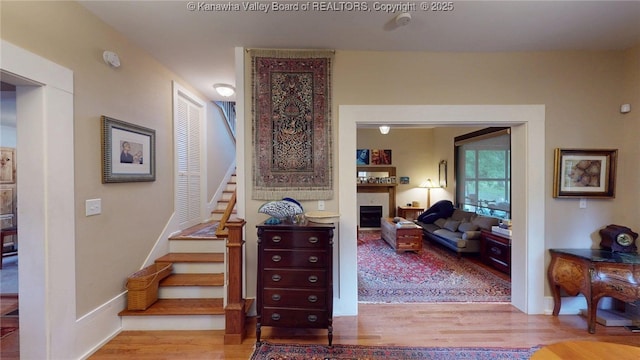 840 13th Ave, Huntington, WV 25701 - stairway featuring wood finished floors, a fireplace, and baseboards