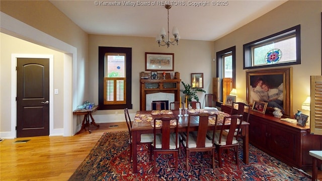 840 13th Ave, Huntington, WV 25701 - dining room featuring wood finished floors, a chandelier, and baseboards