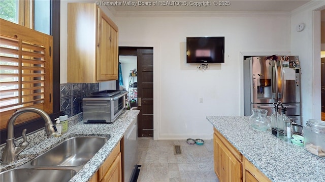 840 13th Ave, Huntington, WV 25701 - kitchen featuring a sink, stainless steel appliances, baseboards, crown molding, and light stone counters