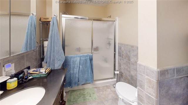 840 13th Ave, Huntington, WV 25701 - bathroom featuring tile walls, a shower stall, vanity, wainscoting, and tile patterned floors