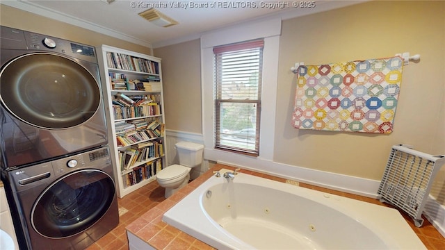 840 13th Ave, Huntington, WV 25701 - bathroom with stacked washing machine and dryer, a whirlpool tub, toilet, and ornamental molding