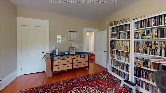 840 13th Ave, Huntington, WV 25701 - sitting room with wood finished floors and wall of books
