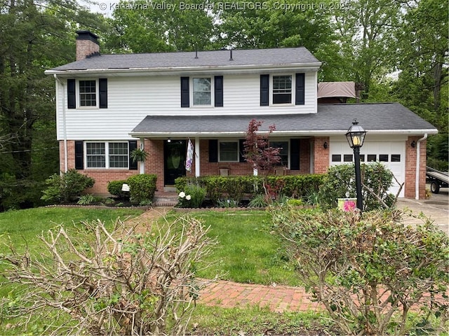 1407 Longridge Rd, Charleston, WV 25314 - traditional-style house featuring brick siding, a garage, a chimney, and driveway