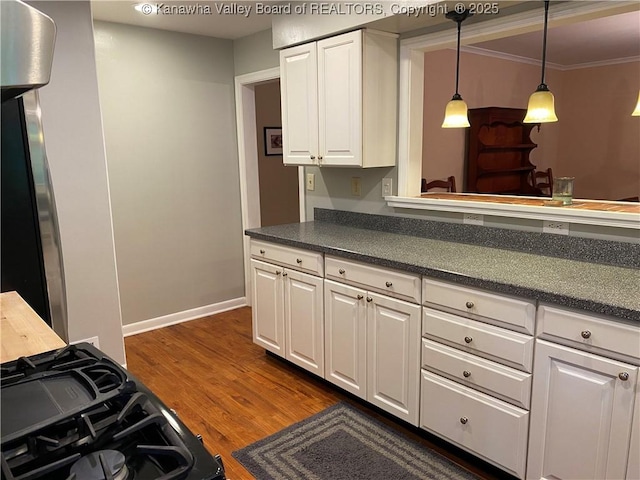 1407 Longridge Rd, Charleston, WV 25314 - kitchen featuring dark countertops, dark wood finished floors, white cabinetry, decorative light fixtures, and crown molding